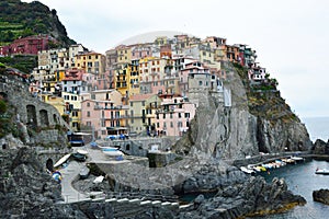 Manarola town with its colorful traditional houses on the rocks over Mediterranean sea, Cinque Terre National Park and UNESCO