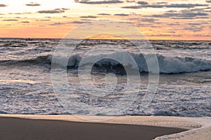 Waves breaking on the beach at Sunrise photo