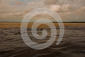 Manaus, Amazonas, Brazil: The merger of the two colored river, Rio Negro, Solimoes