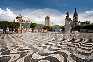 Manaus city sidewalk with Amazon theatre and church in Brazil
