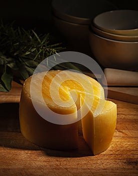 Manchego cheese on dark wooden background