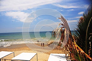 mancora peru beach with clean sand and a blue sea with tourists in loa coast with fantastic sky