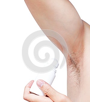 Mand hand holding roll on deodorant with black armpit on white b