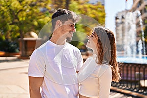 Mand and woman couple hugging each other at park