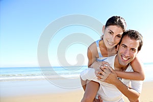 Mand and woman having fun on the seaside photo