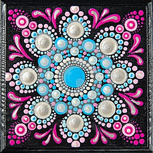 Mandala dot art painting on wood tiles. Beautiful mandala hand painted by colorful dots on black wood. National patterns