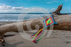 Mandala Eye of God Mexican Huichol Crafts on trunk in Sayulita beach.