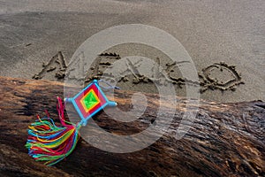 Mandala Eye of God Mexico Huichol Crafts on trunk in Sayulita beach.