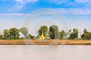 MANDALAY, MYANMAR - DECEMBER 1, 2016: One gold pagoda on the banks of the Irrawaddy river, Burma. Copy space for text.