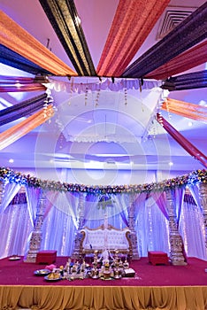 Mandap for a wedding ceremony in a decorated hall