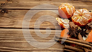 Mandarin orange slices cinnamon sticks and star anise on wooden background