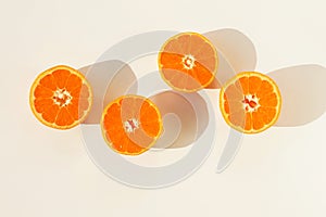 Mandarines, tangerine, clementine slices and shadows top view on white background