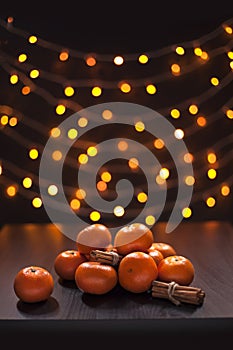 Mandarins and Cinnamon Blurred Defocused Multi Color Lights Background Christmas