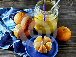 Mandarins and glass jar with juice