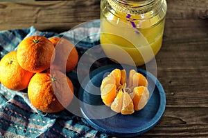 Mandarins and glass jar with juice