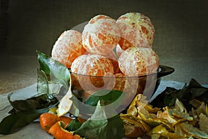 Mandarins peeled in the cup and leaves