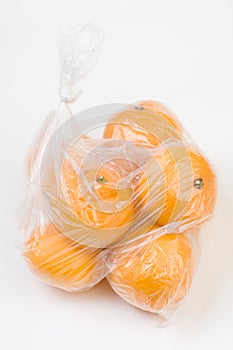 Mandarins in the polyethylene bag isolated photo