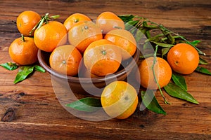 Mandarins tangerines in brown ceramic bowl