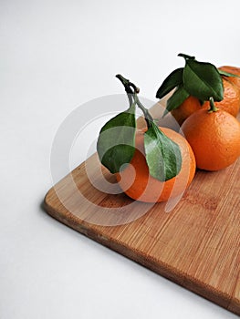 Mandarins, tangerines on a plate on a white backgroun
