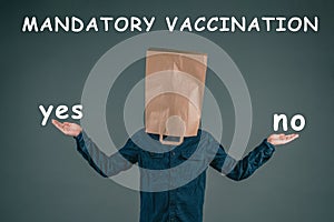 Mandatory vaccination, yes or no, man with paper bag on his head, making a decision