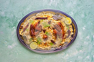 Mandi Kabsa, Yemenis style. Festive dish with baked chicken and rice photo