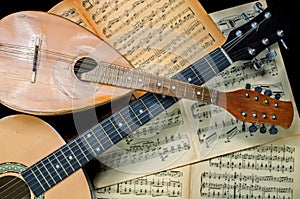 Mandolin and guitar with blurred sheet music books