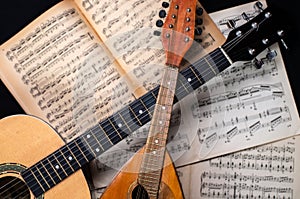 Mandolin and guitar with old blurred sheet music books