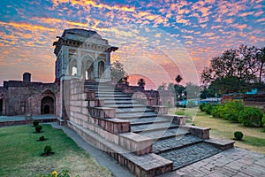 Mandu India, afghan ruins of islam kingdom, mosque monument and muslim tomb. Colorful sky at sunrise.