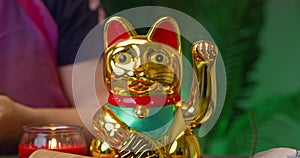 Maneki-Neko, the beckoning cat, a common Japanese figurine believed to bring good luck