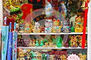 Maneki-neko beckoning cat on display in a souvenir shop in Lon