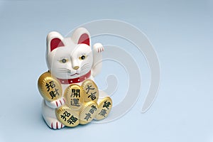 Maneki neko lucky cat doll with hieroglyphs words Health, Happiness, Money, Great Luck, Lucky and Good Fortune
