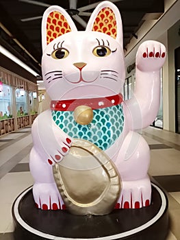 MANEKI NEKO. A small stuffed cat statue is believed to bring good luck to its owner, in Chinese and Japanese culture.