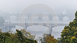 Manes and Charles bridge over Moldau river in mist