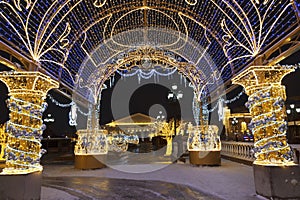 Manezhnaya square during New Year and Christmas holidays with glowing multi-colored arch, Moscow