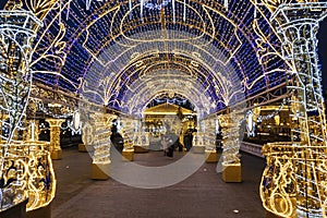 Manezhnaya square during New Year and Christmas holidays with glowing multi-colored arch, Moscow,