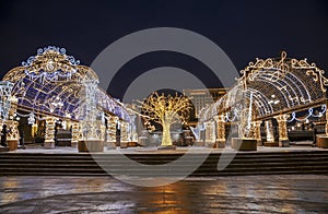 Manezhnaya square during New Year and Christmas holidays with glowing multi-colored arch, Moscow