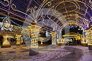 Manezhnaya square during New Year and Christmas holidays with glowing multi-colored arches, Moscow