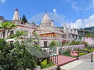 Mangal Dham Pranami Temple surrounded by a garden under the sunlight in Kalimpong, India