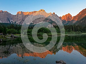 Mangart - Morning sunrise view of Superior Fusine Lake (Laghi di Fusine) with majestic Mount Mangart