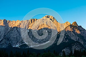 Mangart - Panoramic sunrise view of mountain summit Mount Mangart in Julian Alps, Tarvisio