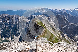 Mangart - Path mark indicaring hiking trail to mount Mangart (Mangrt), border Italy Slovenia