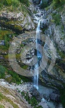 Mangartski waterfall on mountainside on Mangart panorma road in Slovenia