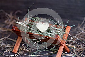 Manger Jesus and the heart of love abstract christmas symbol