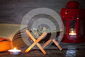 Manger nativity scene lantern and bible in night abstract christmas background