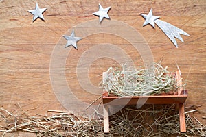 Manger and star of Bethlehem abstracy christmas background nativity scene on wooden board