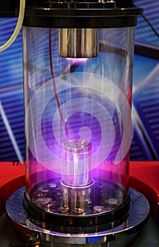 Mangetron sputtering with purple glowing plasma in vacuum glass tube