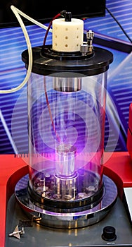 Mangetron sputtering with purple glowing plasma in vacuum glass tube