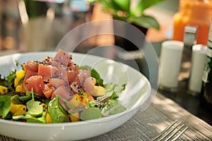 Mango and Ahi Tuna poke salad garnished with seaweed on top close up