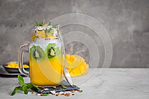 Mango, coconut and chia seeds pudding in glass jar