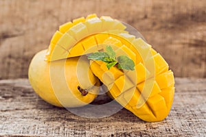 Mango fruit and mango cubes on the wooden table
